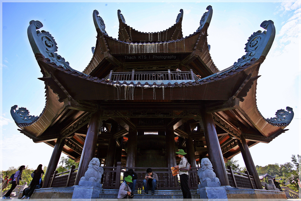 An overview of the architecture at Perfume Pagoda, showcasing tiered roofs, wooden structures, and the integration with the mountainous landscape.