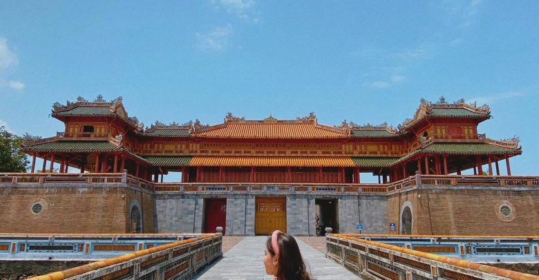 Scenic view of the Imperial City of Hue during spring, showing blooming flowers and clear skies.