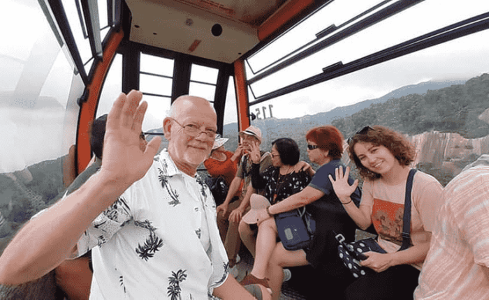 Cable car ascending to the top of Ba Na Hills with lush green mountain scenery.