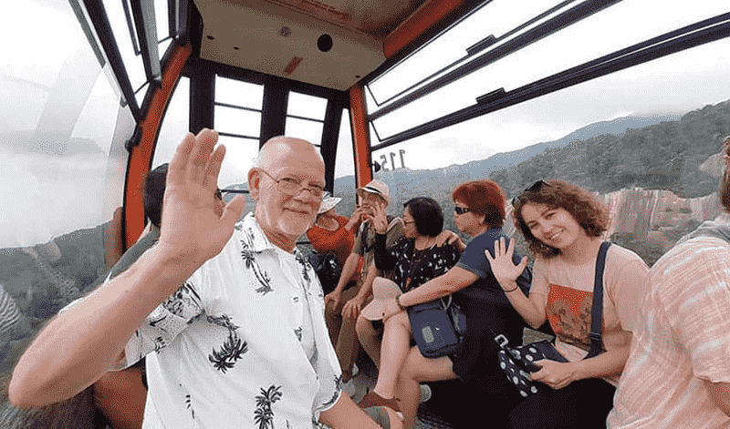 Cable car ascending to the top of Ba Na Hills with lush green mountain scenery.