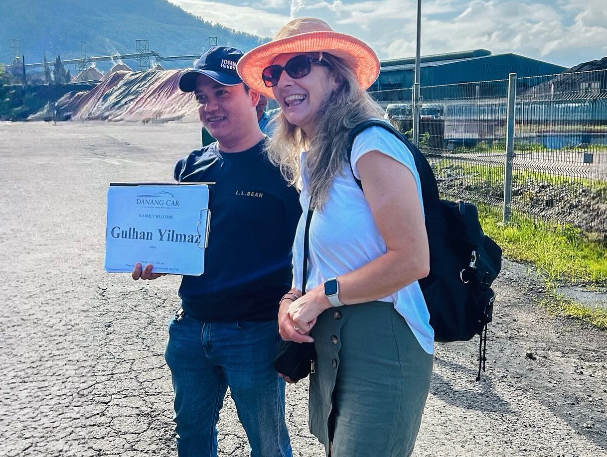 VnCarRentals.com driver holding a sign welcoming tourists at Chan May Port for a trip to Ba Na Hills