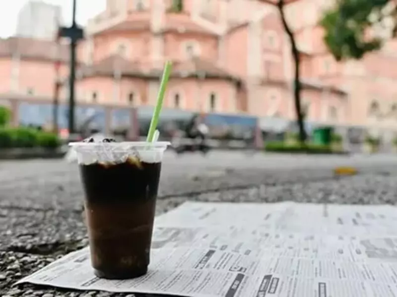 People enjoying iced coffee in a cafe near Notre Dame Cathedral in Ho Chi Minh City.