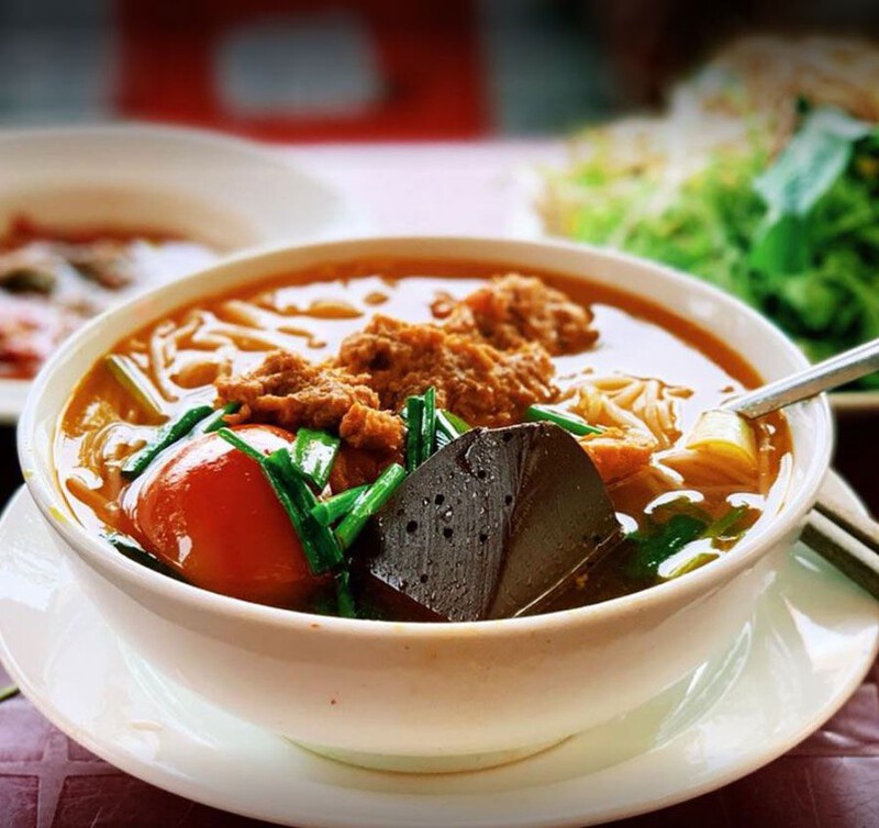 Crab Soup Noodles (Bún Riêu Cua) served at Ben Thanh Market with crab paste, tofu, and rich broth.