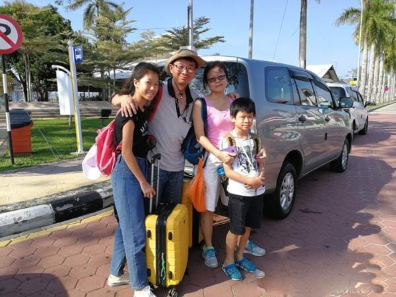 A happy family enjoying a private car ride from Ho Chi Minh City to Can Tho with VNCarRentals.com.