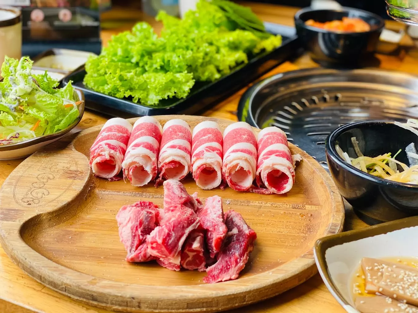 Gogi House Nha Trang showcasing Korean barbecue with pork belly and beef dishes.