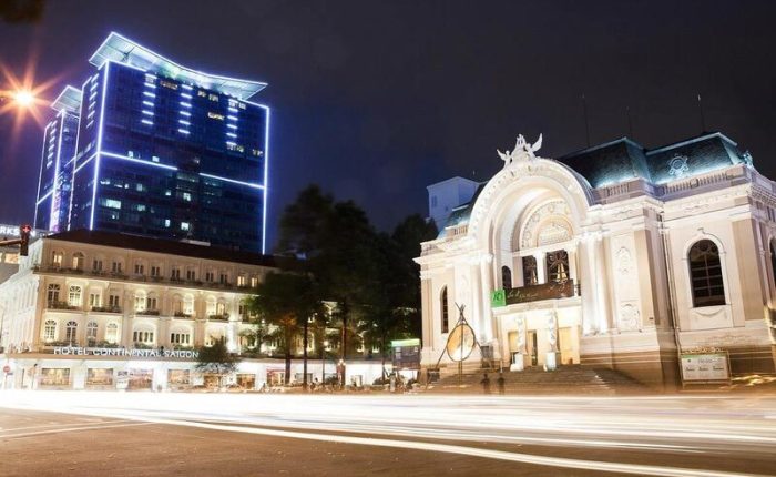 The Ho Chi Minh City Opera House glowing at night with intricate details visible.