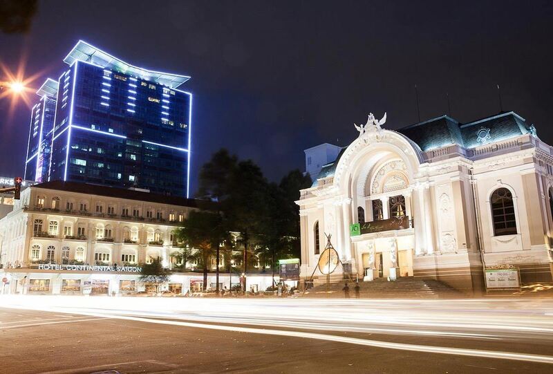 The Ho Chi Minh City Opera House glowing at night with intricate details visible.