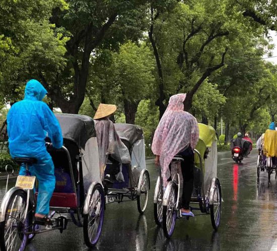 Cyclo ride through the rainy streets of Hue, offering a slow-paced exploration of the city.