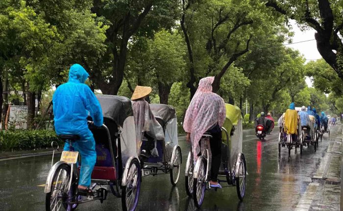 Cyclo ride through the rainy streets of Hue, offering a slow-paced exploration of the city.