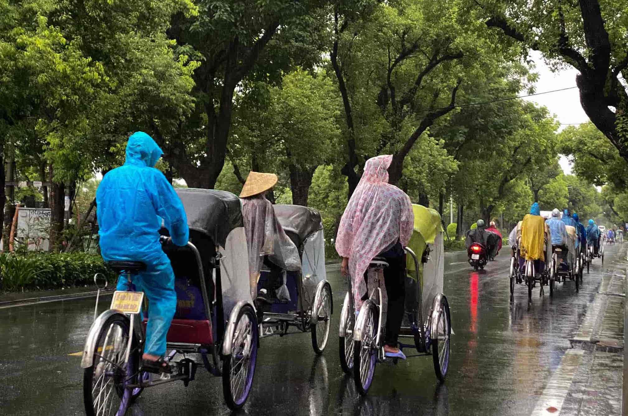 Cyclo ride through the rainy streets of Hue, offering a slow-paced exploration of the city.