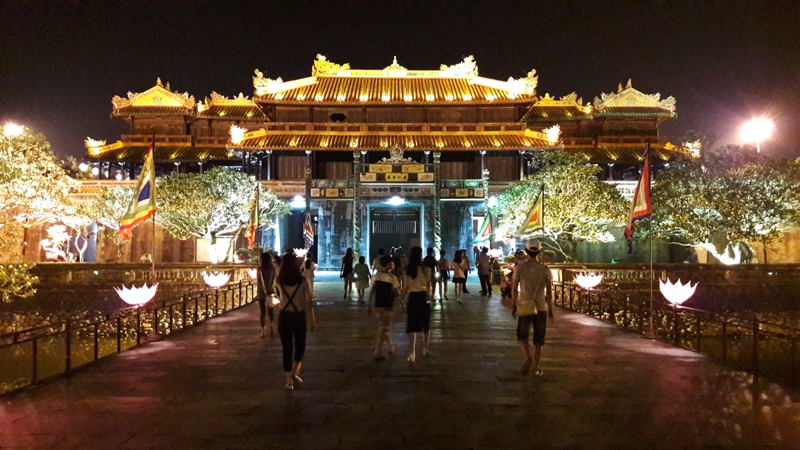 The Imperial City of Hue illuminated at night, featuring traditional ceremonies and vibrant performances.