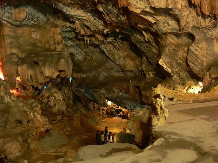 Interior view of Huong Tich Cave, showcasing its remarkable rock formations and tranquil atmosphere.