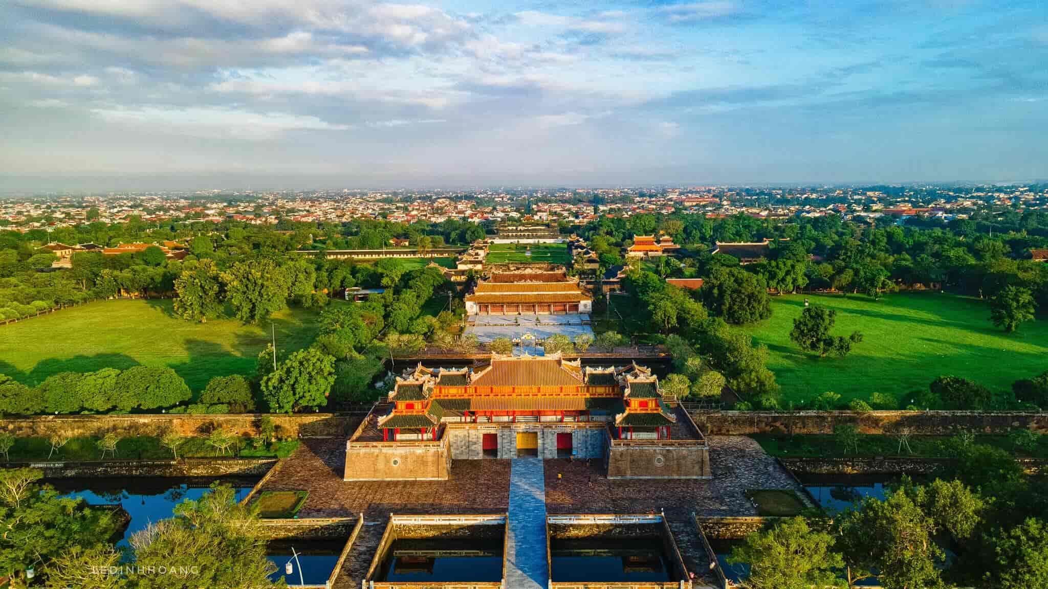 A panoramic view of the Imperial City of Hue along the Perfume River, showcasing its grandeur and historical architecture.