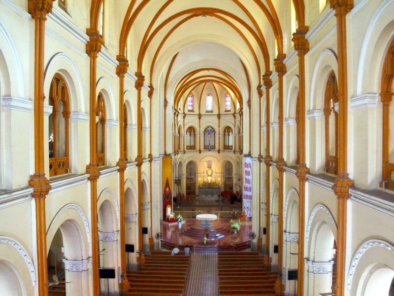 Interior view of Notre Dame Cathedral Saigon with stained glass windows and intricate architecture.