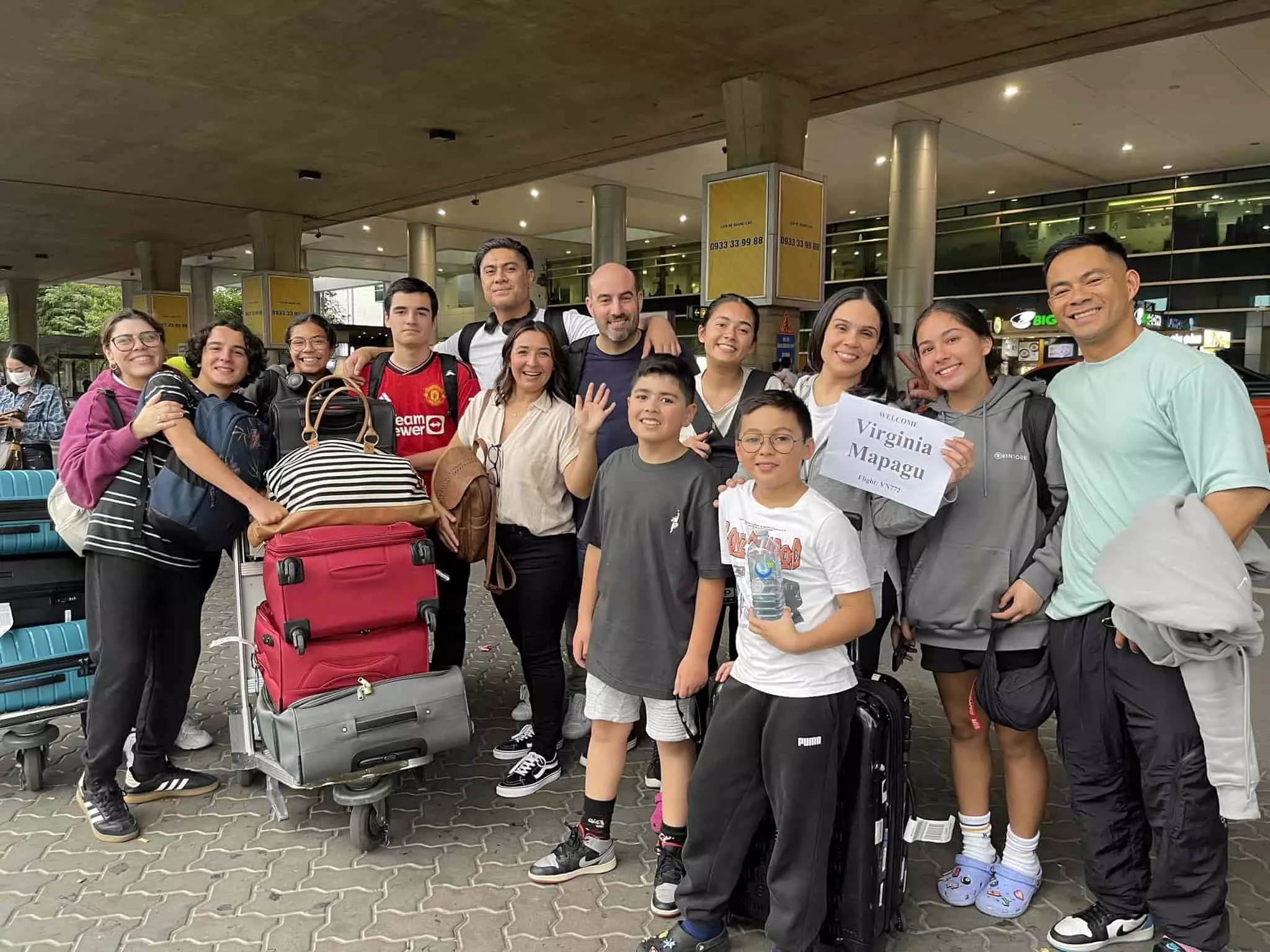 Driver with welcome sign for airport transfer from Noi Bai Airport to Hanoi City Center