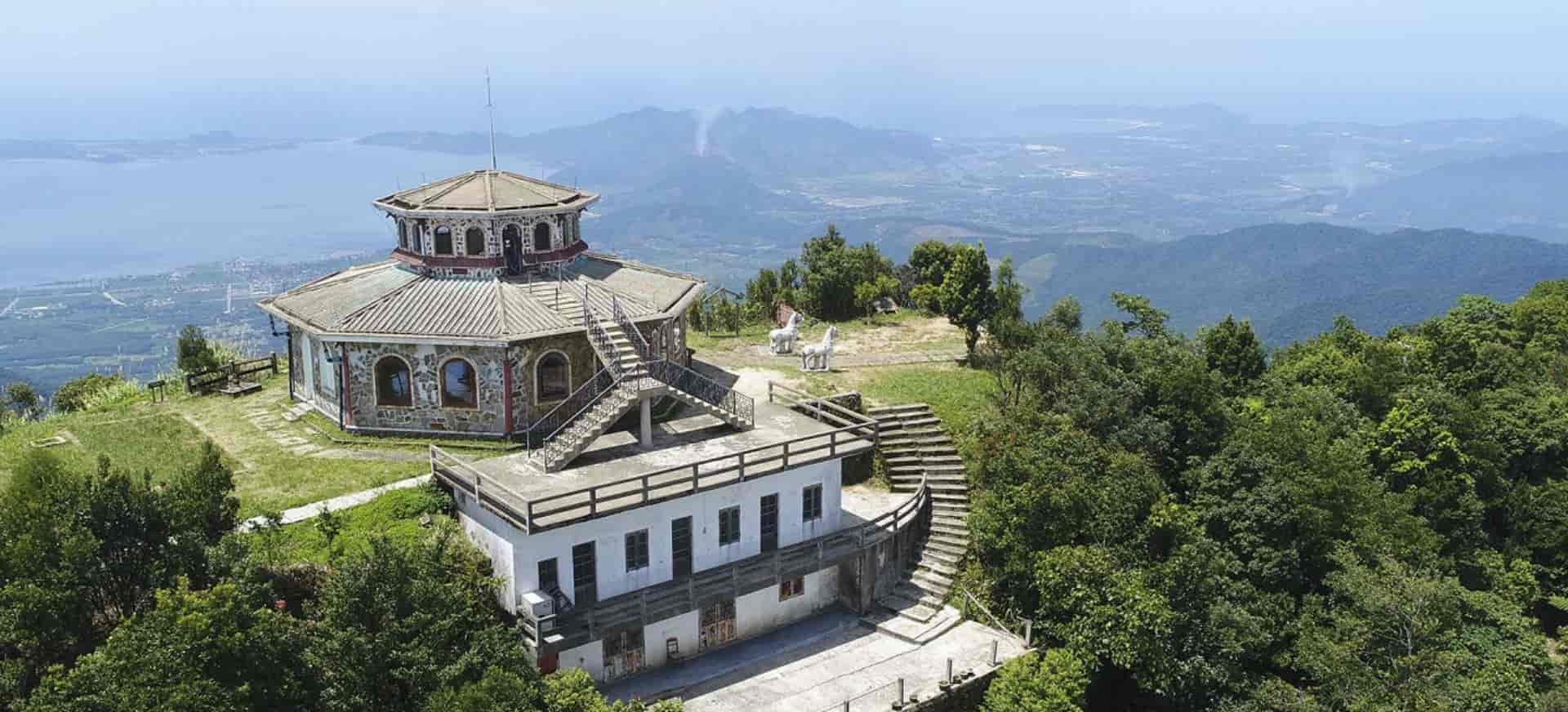 Panoramic view from the summit of Vong Hai Dai Bach, showcasing lush forests and sea bays.