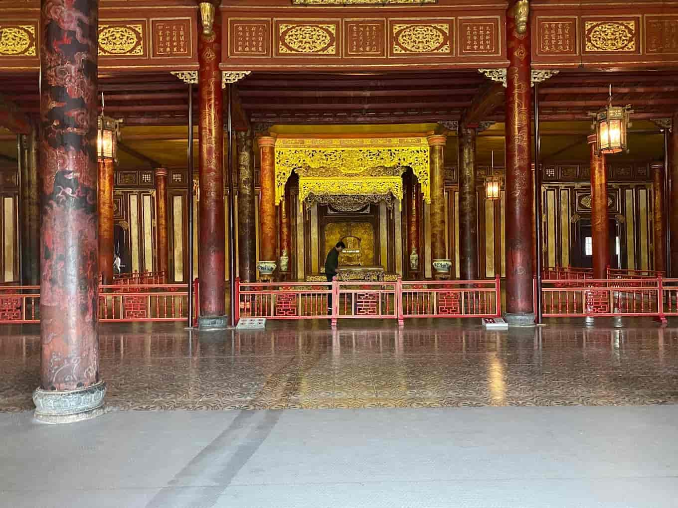 Thai Hoa Palace with its intricate dragon carvings and traditional Vietnamese architecture, representing the power of the Nguyen dynasty.